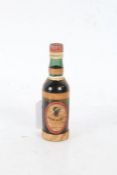 Miniature bottle of "Rhum Negrita" rum, the raffia wrapped bottle with oval label, 12.5cm high