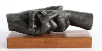 20th century metal sculpture, depicting two clasped hands, initialled SC and numbered 7/30,