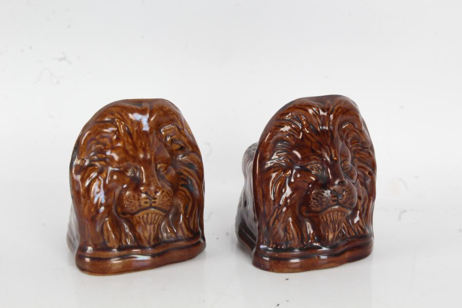Pair of 19th Century treacle glazed sash window rests, with lion mask decoration, 13cm high