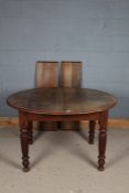 Victorian pull out extending dining table, the round ended top with two extra leaves, raised on