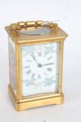 French brass cased and enamel carriage clock, the white enamel dial with blue and gilt floral sprays