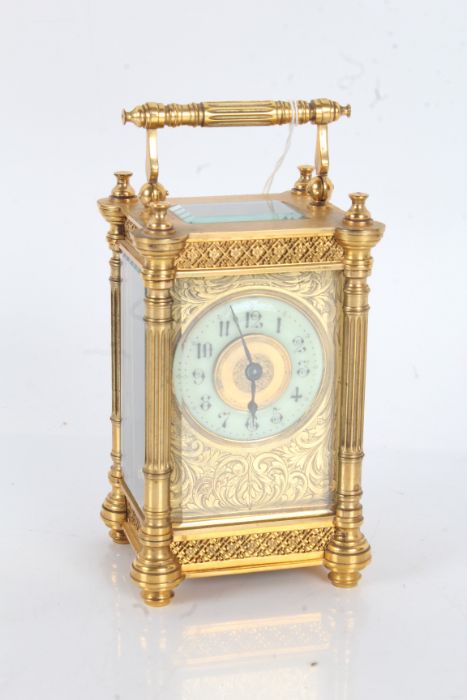 French brass carriage clock, having foliate engraved dial with enamel chapter ring and arabic