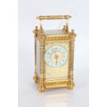 French brass carriage clock, having foliate engraved dial with enamel chapter ring and arabic