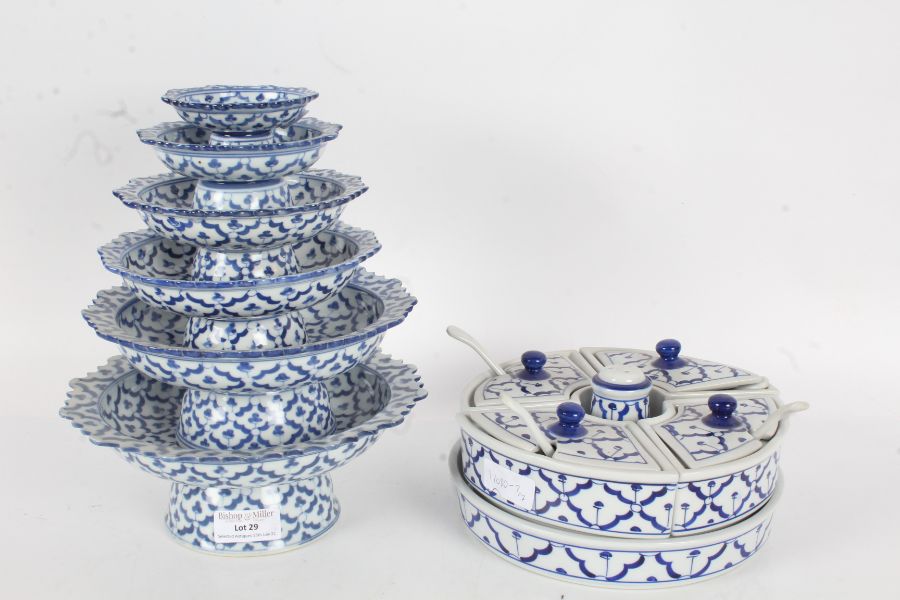 Collection of blue and white porcelain dishes of graduating sizes decorated with a repeating