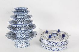 Collection of blue and white porcelain dishes of graduating sizes decorated with a repeating