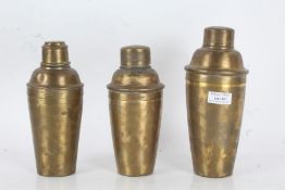 Three base metal cocktail shakers, one stamped Farrow & Jackson, the tallest 22cm (3)