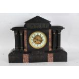 Black slate mantle clock, the white dial with Arabic numerals, with a arched pediment above a