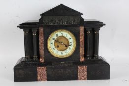 Black slate mantle clock, the white dial with Arabic numerals, with a arched pediment above a