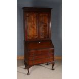 Edwardian mahogany bureau bookcase, the glazed upper section above a sloping fall enclosing a pigeon