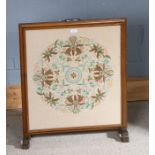 20th century needlework firescreen with a foliate decorated panel, 67cm high 57cm wide