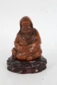 Chinese carved bamboo depiction of a seated monk, , on a hardwood stand, 14.5cm high