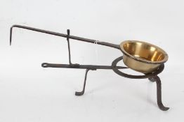 George III long handled bronze skillet, with an associated long handled iron trivet, 53cm long