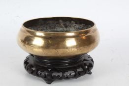 19th Century Chinese bronze censer, of plain bulbous from, raised on a pierced hardwood stand,