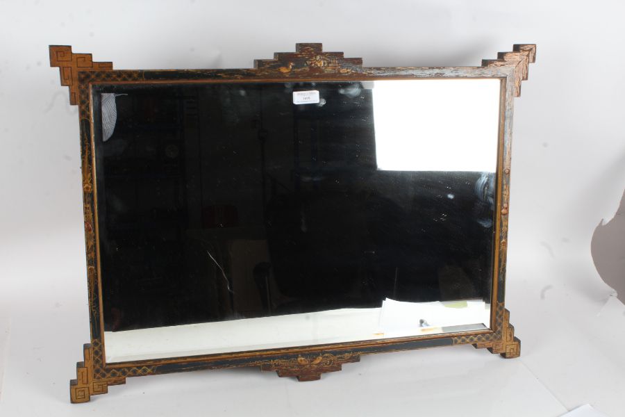 20th century Chinoiserie black lacquered mirror, with gilt accents, depicting scenes and beveled