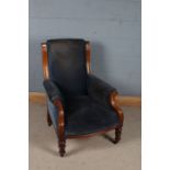 Victorian mahogany deep seated armchair, with blue upholstery and raised on knopped tapering legs