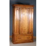 Victorian satin birch wardrobe, the moulded cornice above a single door enclosing two pull out rails