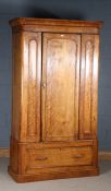 Victorian satin birch wardrobe, the moulded cornice above a single door enclosing two pull out rails