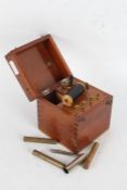 K Schall coil with a dry cell housed within a wooden case with carrying handle, 18cm high 13cm deep