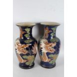 Pair of large Chinese vases, each with dragons on a blue ground, 2cm tall (2)