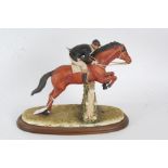 Capodimonte Mariani porcelain figure group, in the form of horse and rider jumping over a fence,
