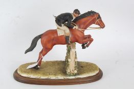 Capodimonte Mariani porcelain figure group, in the form of horse and rider jumping over a fence,