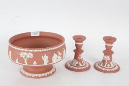 Wedgwood terracotta pedestal bowl, 20cm diameter, together with a pair of candlesticks, 12.5cm tall,