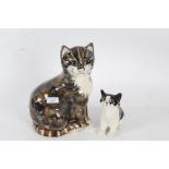 Winstanley pottery cat, in black and white with green glass eyes, 14cm high, together with one other