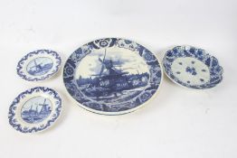 Two Delft blue and white chargers, 39cm diameter, two Delft plates, 19.5cm diameter, all decorated