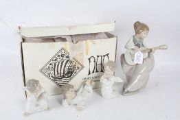 Three Lladro porcelain cherubs, and a Nao figurine of a lady playing a guitar (4)