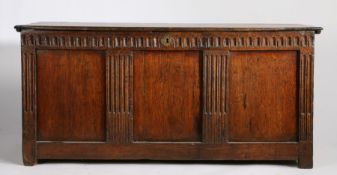 18th Century oak coffer, the hinged lid above a plain panelled front and fluted columns, 132cm wide,