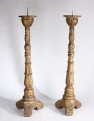 A large pair of Regency pricket sticks, the spike tops above acanthus leaf carved columns and a