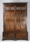 17th Century style oak enclosed cupboard, the cornice above long thumb moulded and lozenge carved