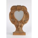 An 18th Century oak pier mirror, the later central heart mirror with C scrolls and arching frame,