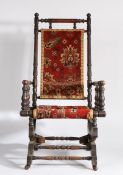 An American type rocker armchair, the turned stretcher with rug back and seat above the sprung base,