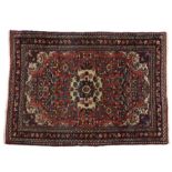 Persian Zaronim Hamadan rug, centred with a flower head within a floral pattern on red ground, 150cm