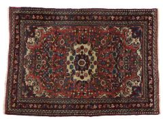 Persian Zaronim Hamadan rug, centred with a flower head within a floral pattern on red ground, 150cm