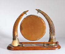 Oak, copper and antler dinner gong, the circular copper gong raised on two antler supports, on an