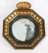 Regency convex wall mirror, the gilt and ebonised orb decorated octagonal frame with shell form