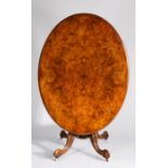 Victorian walnut oval loo table, the quarter veneered oval top with boxwood floral inlay, raised