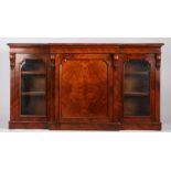 Victorian mahogany breakfront bookcase, the moulded frieze above a central panelled cupboard door