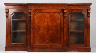 Victorian mahogany breakfront bookcase, the moulded frieze above a central panelled cupboard door