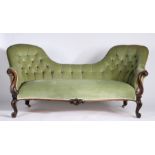 Victorian walnut double chair back settee, having green button back upholstery, carved scrolling