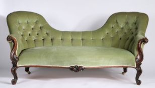 Victorian walnut double chair back settee, having green button back upholstery, carved scrolling