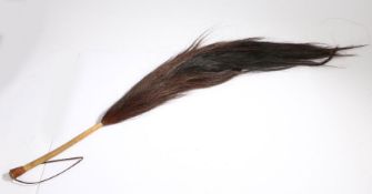 Horse tail hair fly whisk, with plaited brown leather carrying handle, 125cm long