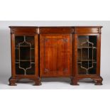 Early 20th century mahogany inverted breakfront bookcase, with floral carved moulding above a