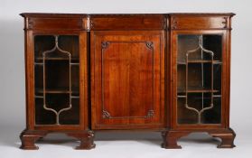 Early 20th century mahogany inverted breakfront bookcase, with floral carved moulding above a