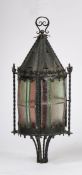 Ecclesiastical style hanging lantern, with a cone top above fleur de lis finials above the