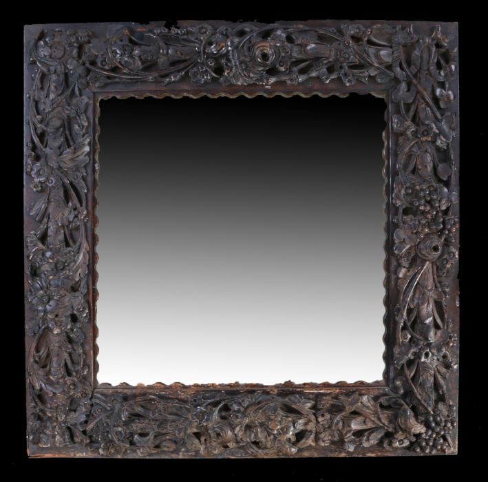 A late 19th Century heavily carved oak framed mirror, the mirror plate within the berry and leaf - Image 2 of 2