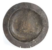 A pewter dish, probably 17th century, excavated, English Having a plain rim and flat well, the