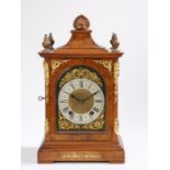 Victorian walnut mantel clock, the shell form pediment flanked by swirled brass finials, the